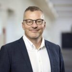 Vi bygger ikke kun teams – vi bygger bro mellem mennesker Portræt af Torsten Bielefeldt Schlägelberger, CEO for Conscensia, ledsaget af citat om at bygge bro mellem mennesker, kulturer og forretninger gennem nearshoring.