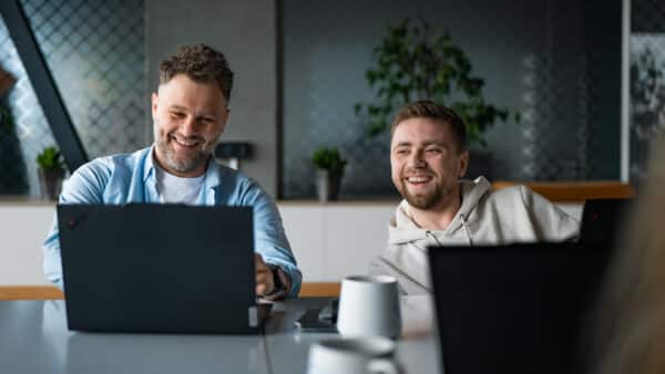 Software engineers collaborating during a working session at Conscensia, a Danish-owned software development partner.